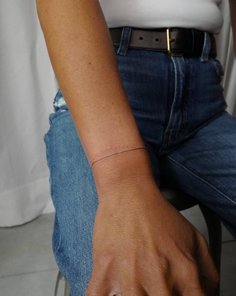 Minimalistic style wristband tattoo.