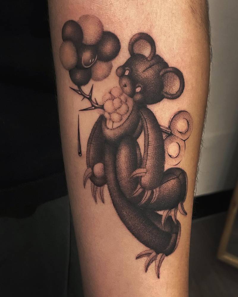 Dotwork style teddy bear tattoo located on the inner forearm.