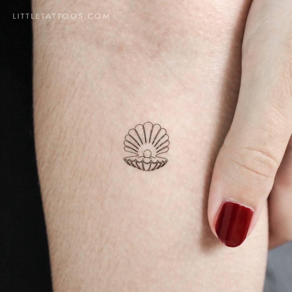 Fine line style scallop temporary tattoo located on the inner forearm.