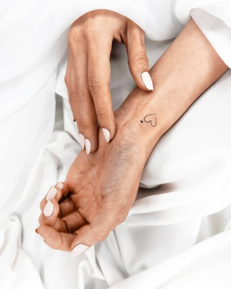 Minimalistic style hearts tattooed on the wrist.