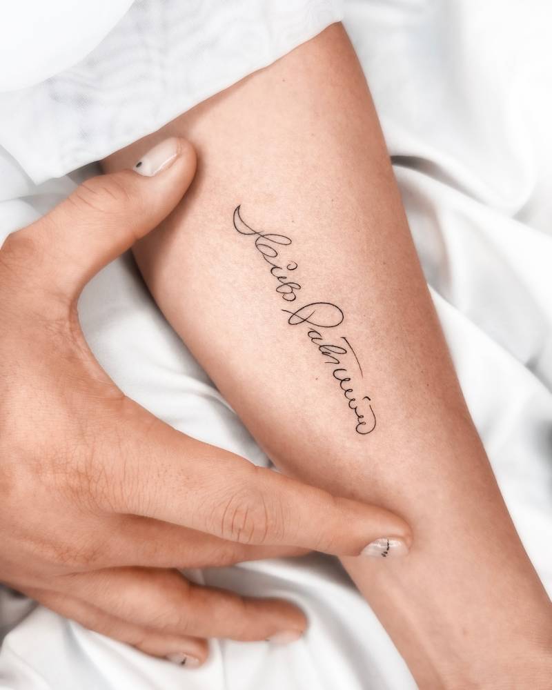Signature tattoo located on the inner forearm.