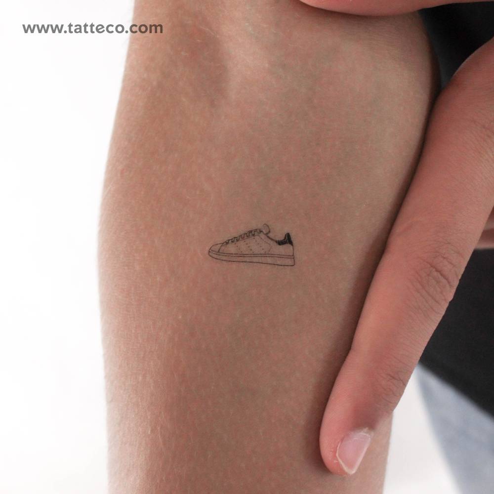 Fine line style Adidas Stan Smith temporary tattoo located on the inner forearm.