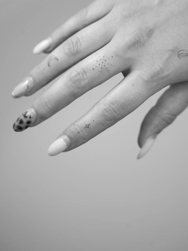 Minimalistic style ornamental finger composition tattoos.