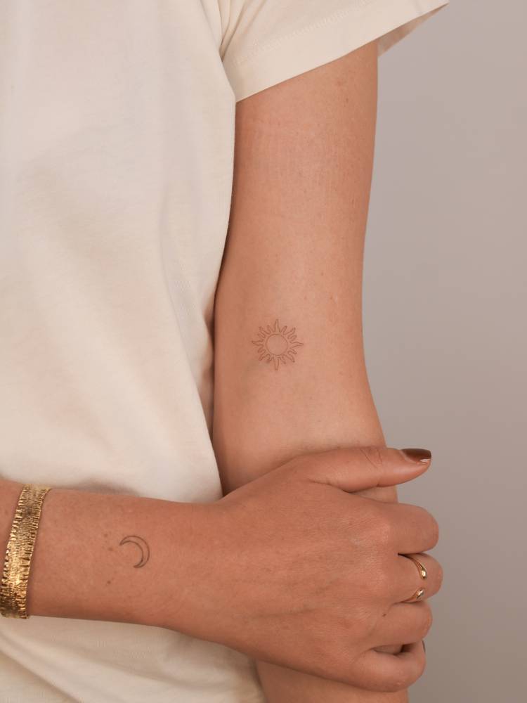 Individual matching sun (fresh) and moon (healed) tattooes.