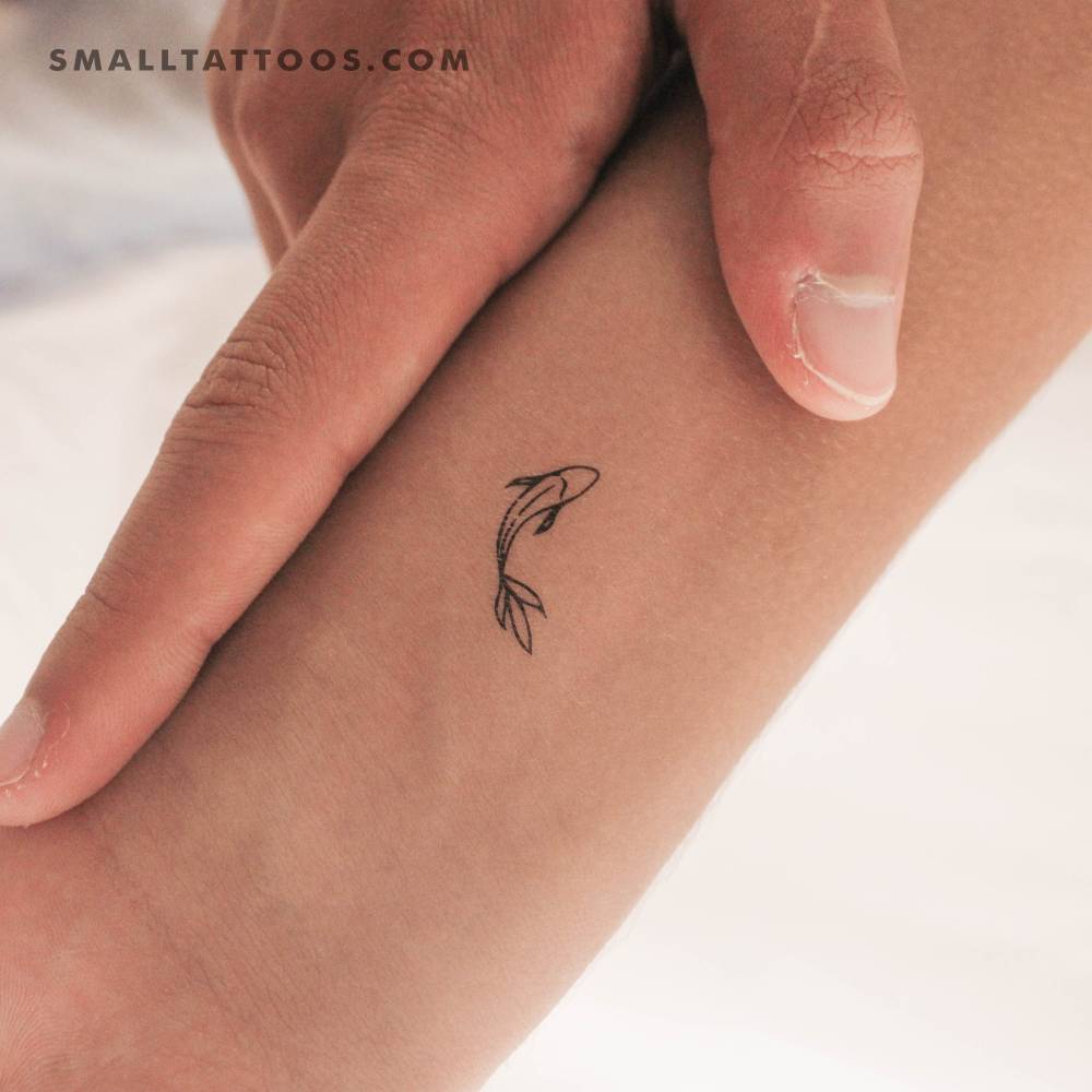 Minimalist koi fish temporary tattoo located on the wrist.