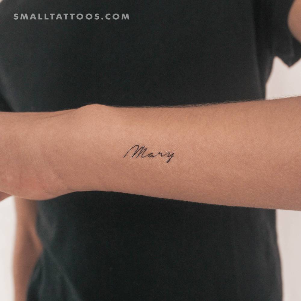 Handwritten name "Mary" temporary lettering tattoo located on the wrist.