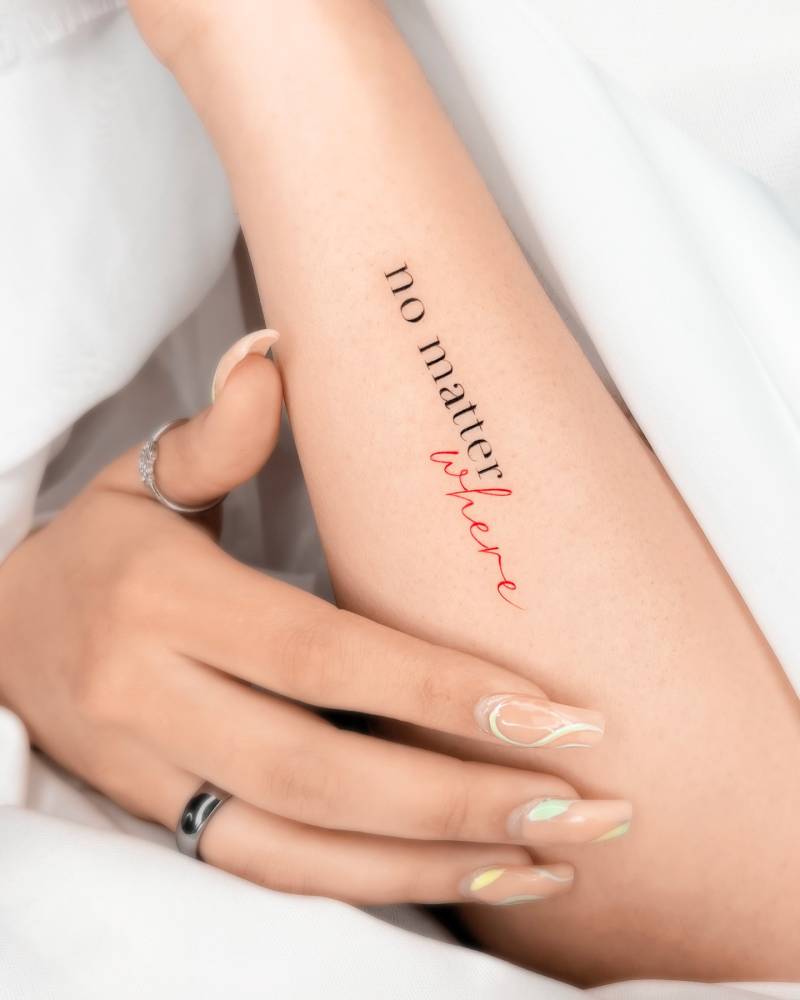 "No matter where" lettering tattoo located on the forearm.