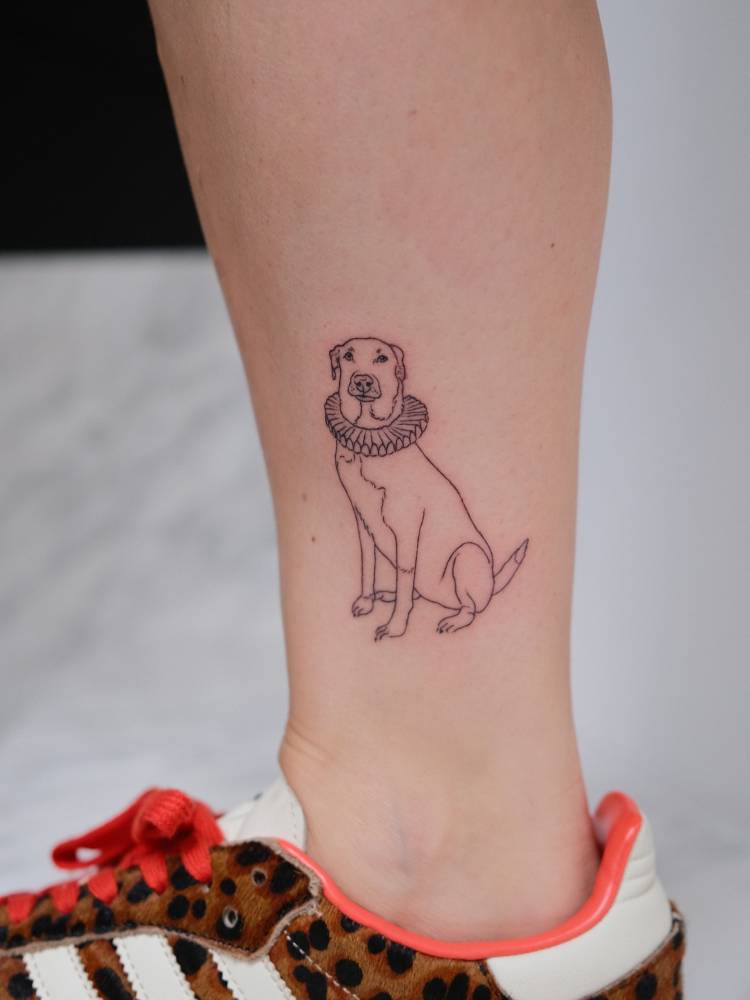 Labrador tattoo in fine line style located on the ankle.