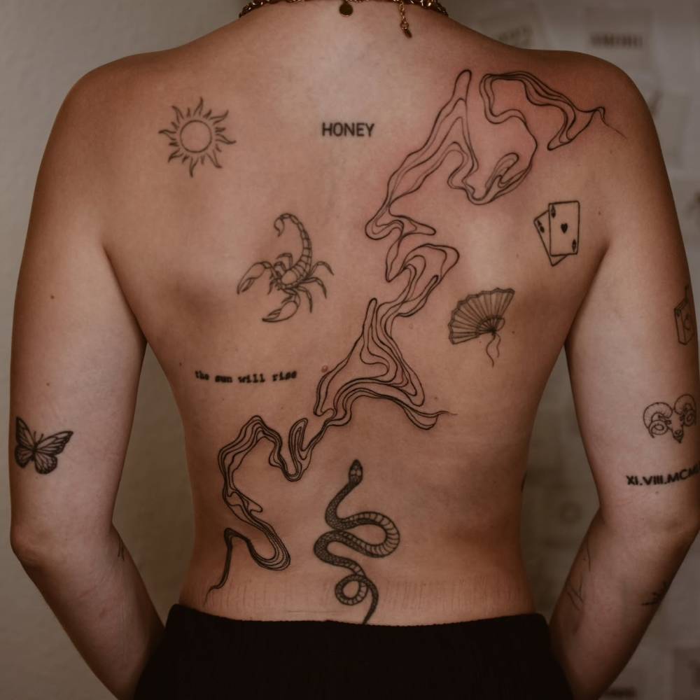 Illustrative style back composition tattoos.
