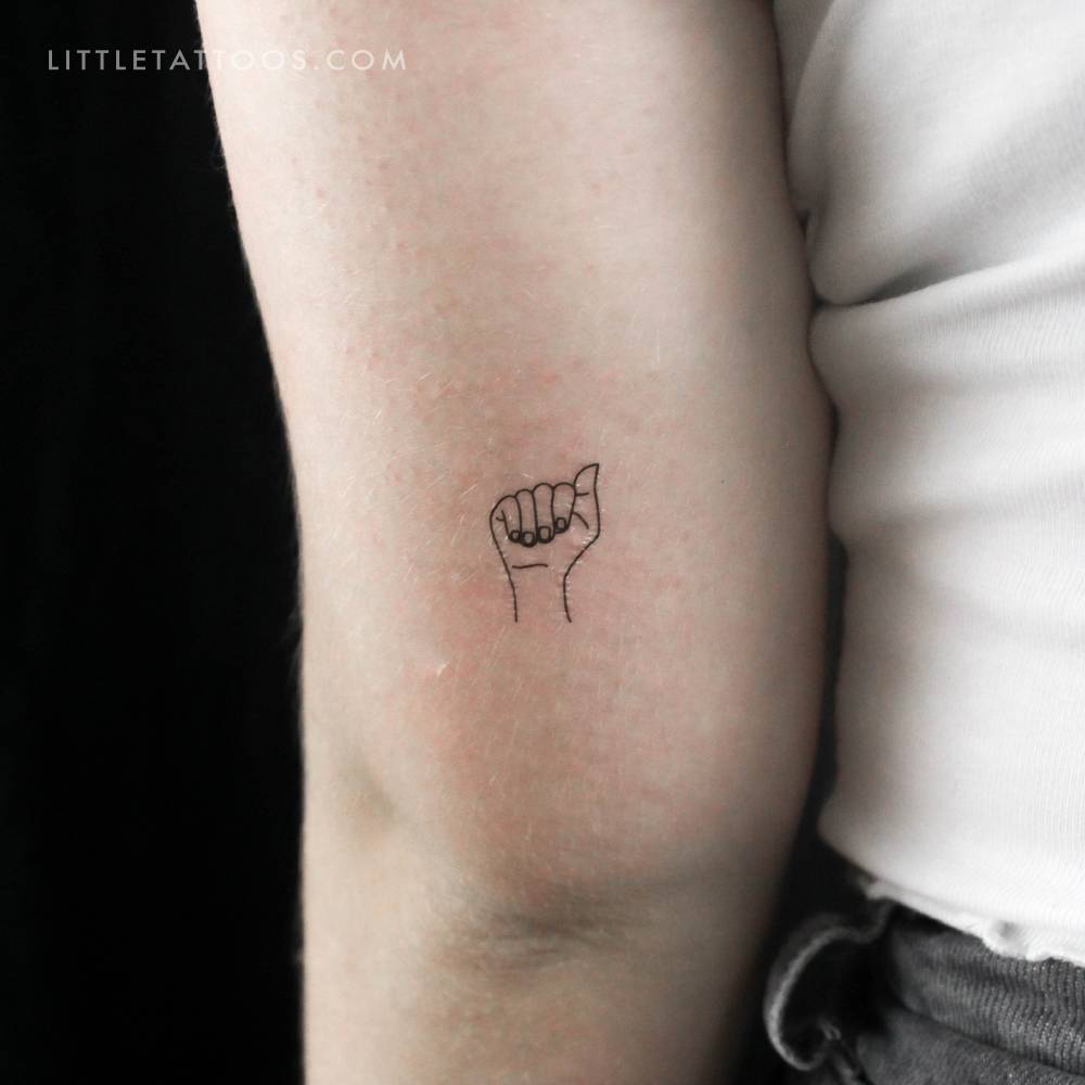 Sign language letter "A" temporary tattoo placed on the tricep.