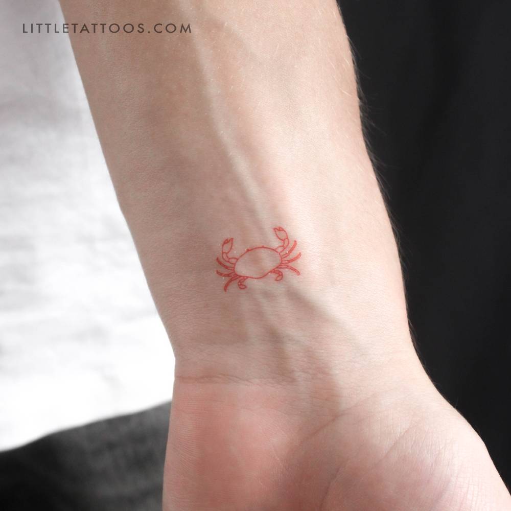 Fine line style red crab temporary tattoo located on the wrist.