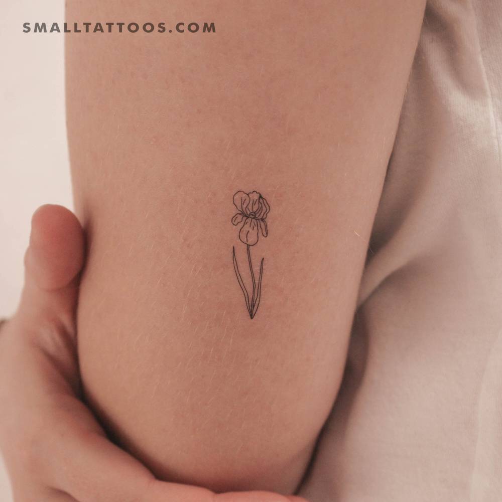 Fine line style iris temporary tattoo located on the tricep.