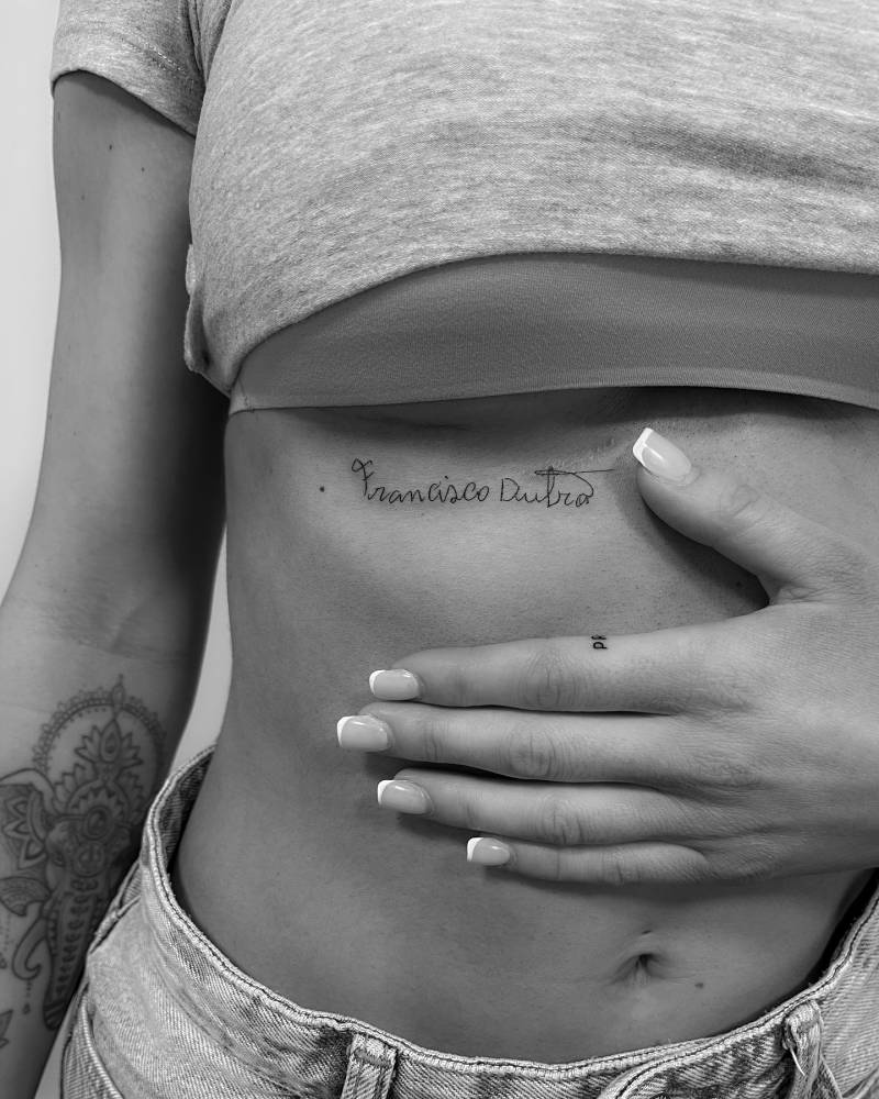 Signature tattoo located on the under boob.