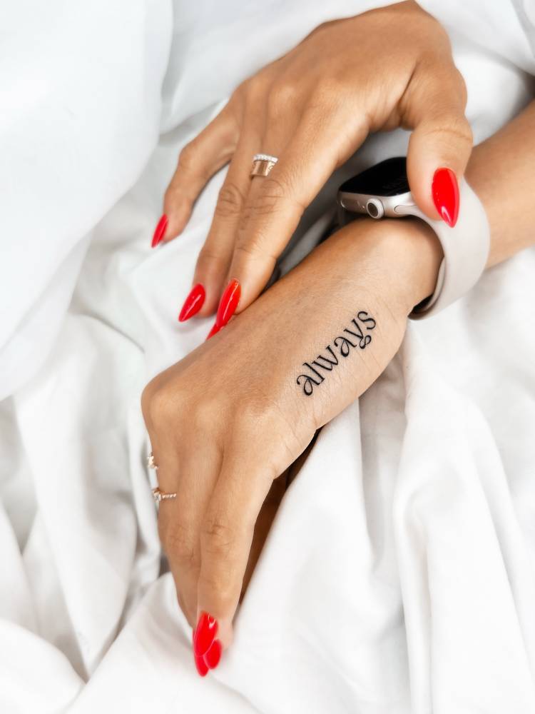 Serif font word "always" tattooed on the hand.