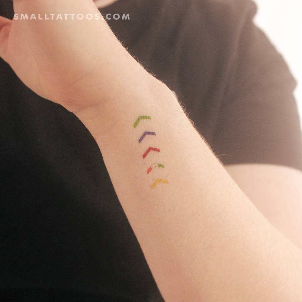 One Direction mic color arrows temporary tattoo located on the wrist.