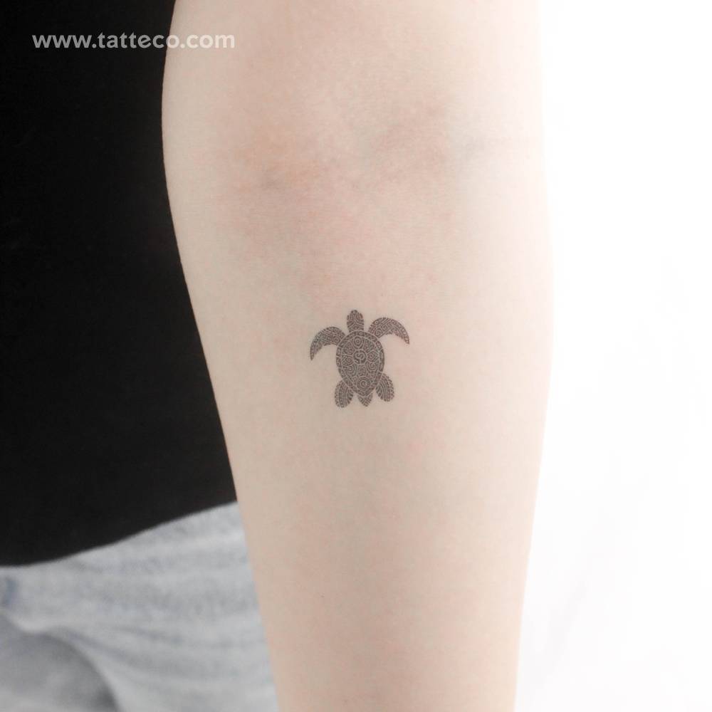 Tribal sea turtle temporary tattoo located on the inner forearm.