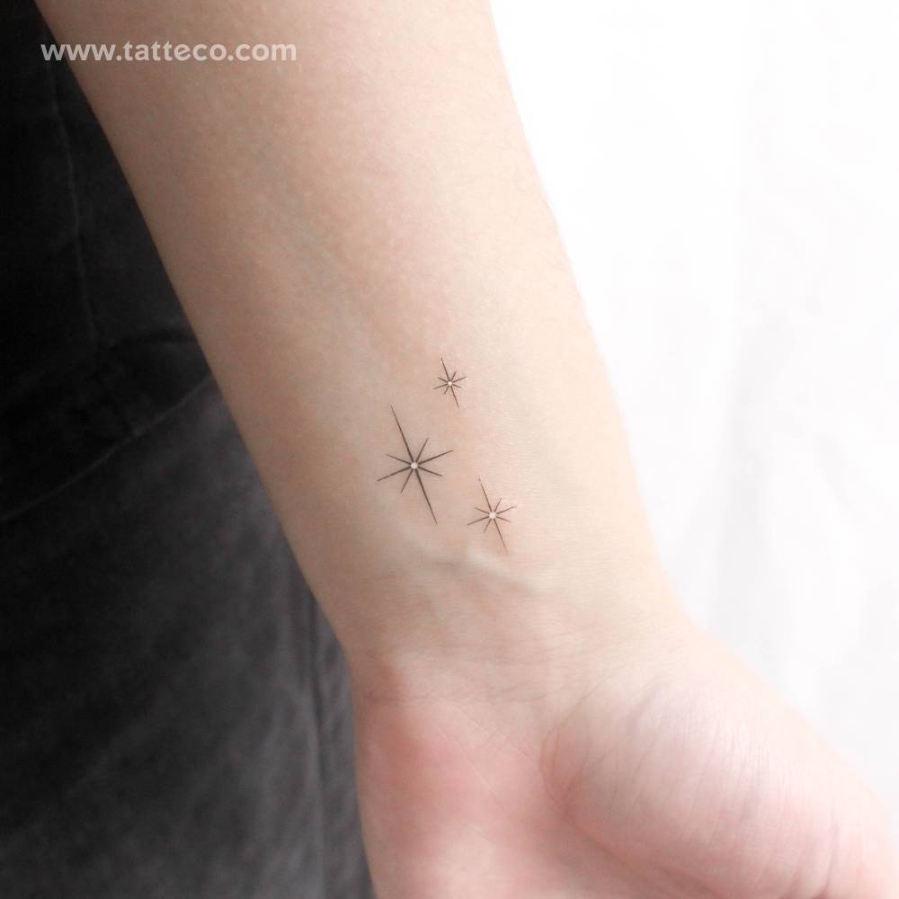 Three shinning sparkles temporary tattoo located on the wrist.