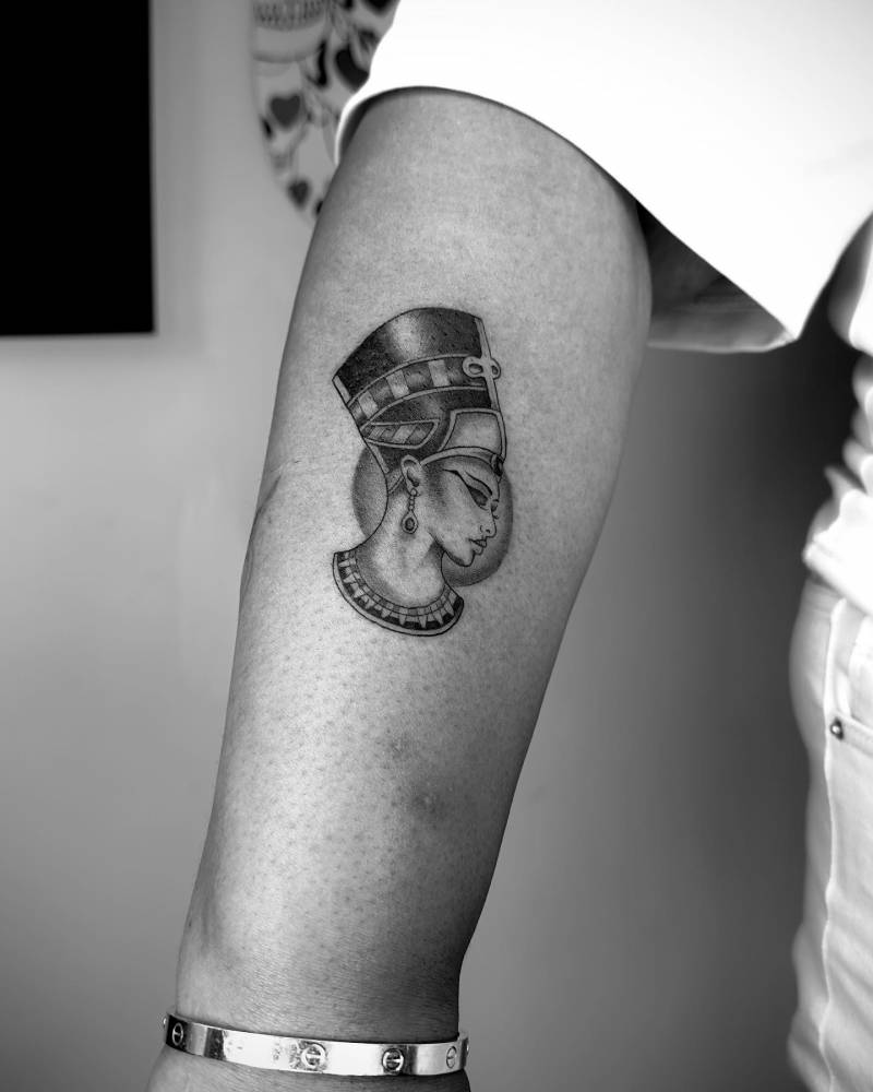 Nefertiti tattoo located on the forearm, illustrative style.