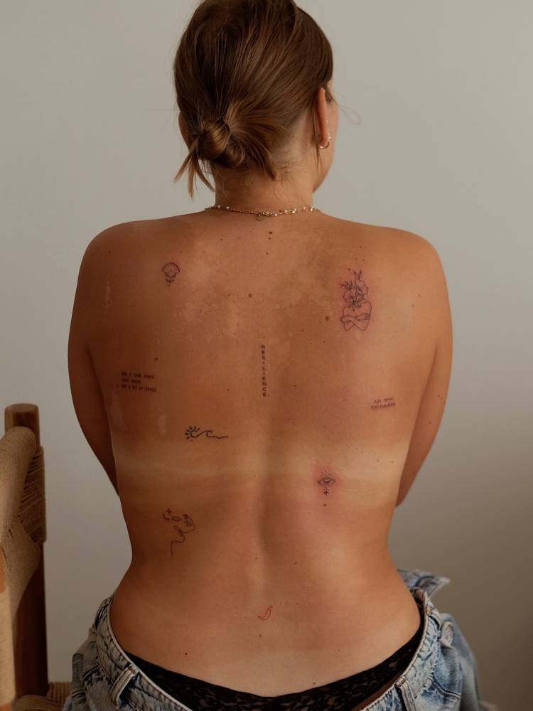 Fine line style back composition tattoos.