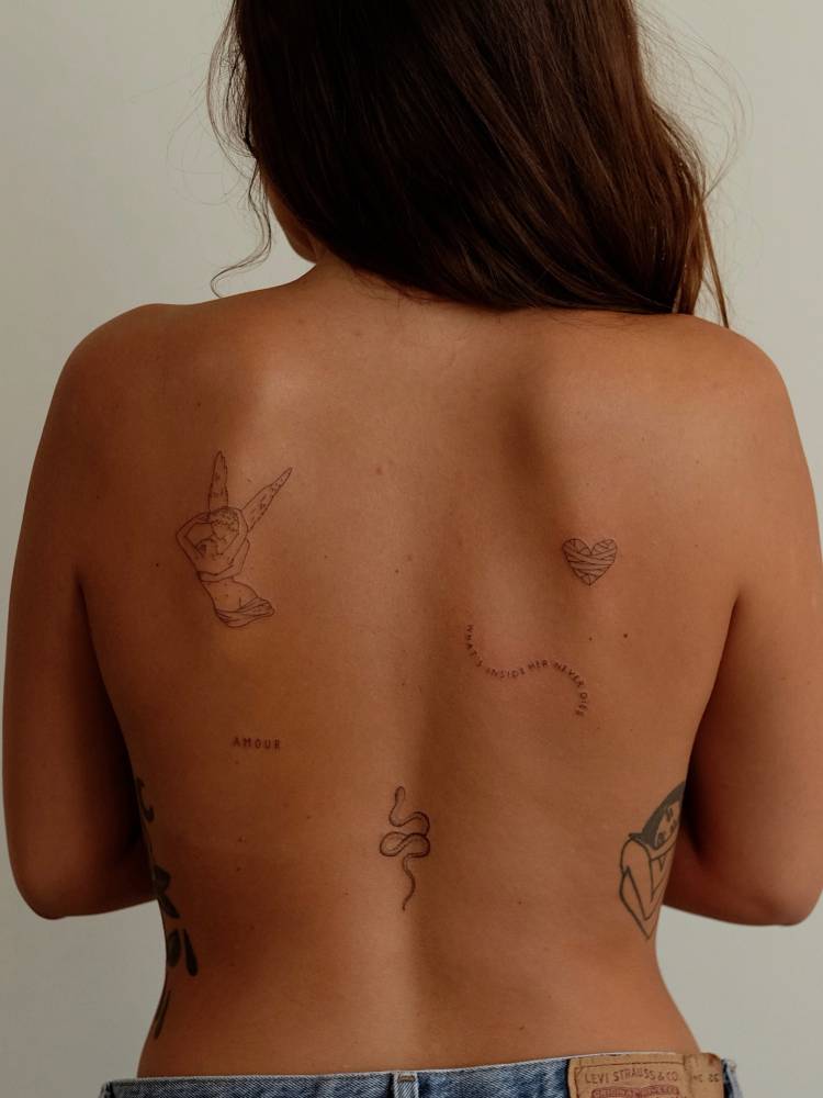 Back composition tattoos in fine line style.