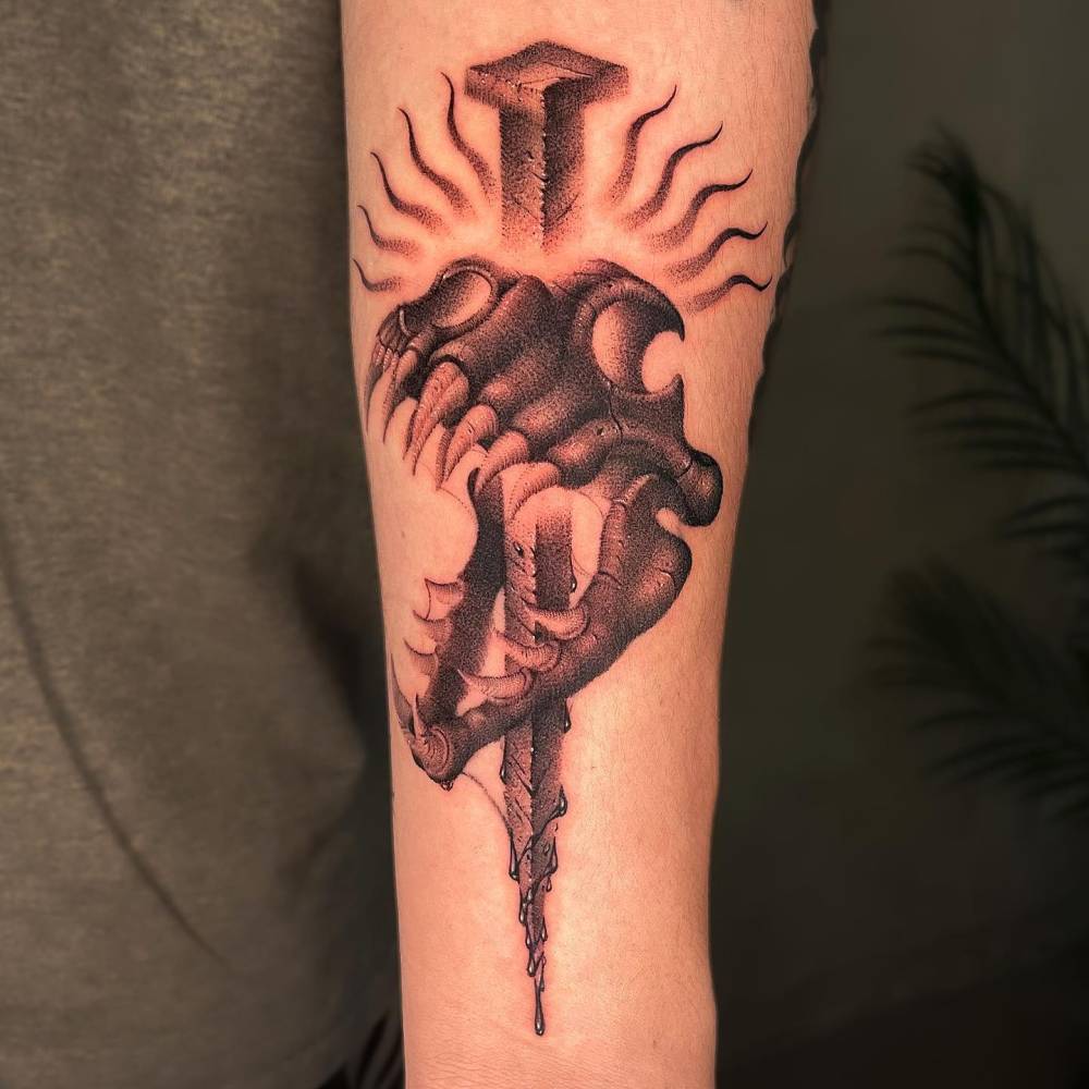 Dotwork style T-Rex skull and nail tattoo located on the inner forearm.