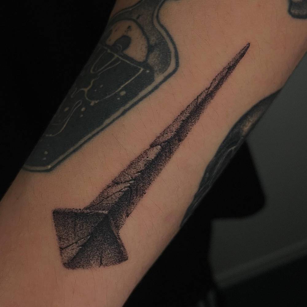 Nail tattoo in dotwork style located on the forearm.