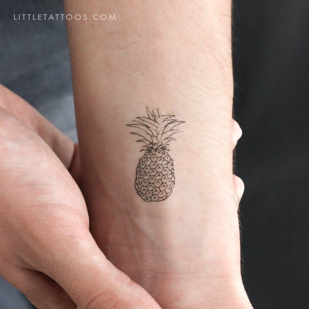 Fine line style pineapple temporary tattoo located on the wrist.