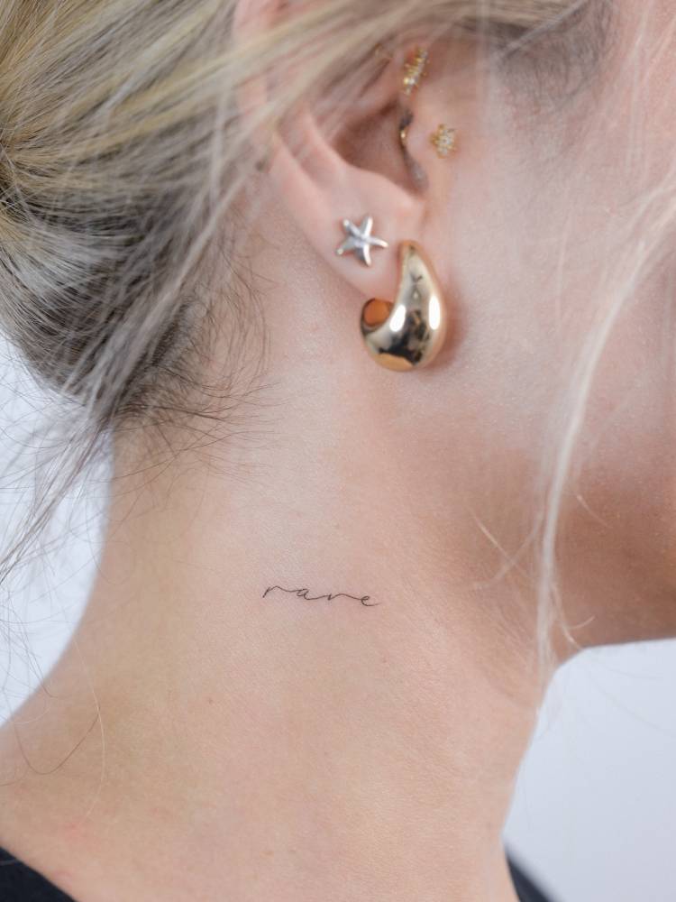 Lettering tattoo of the word "rare" placed on the neck.