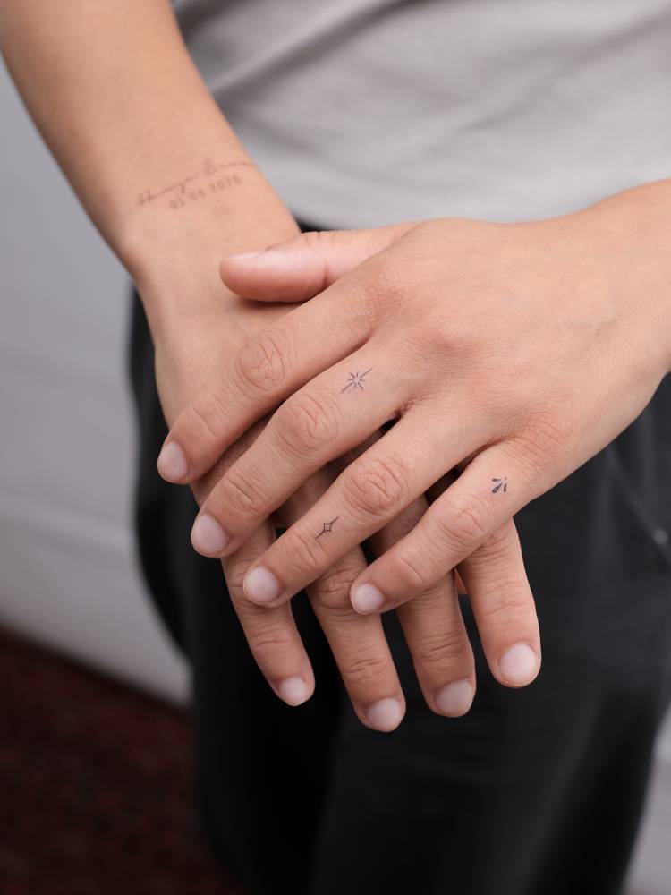 Minimalistic style finger composition tattoos.