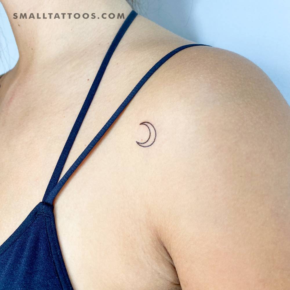 Crescent moon outline temporary tattoo located on the shoulder.