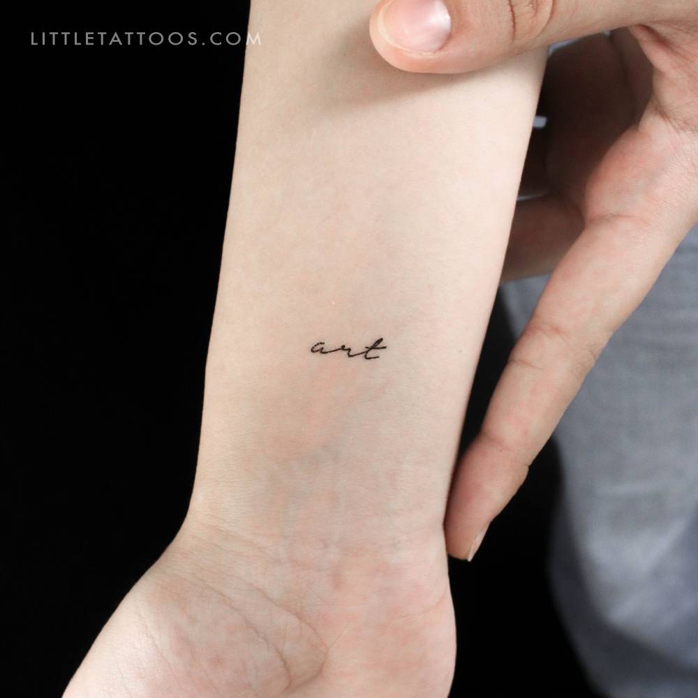 Handwritten font word 'art' temporary tattoo located on the wrist.