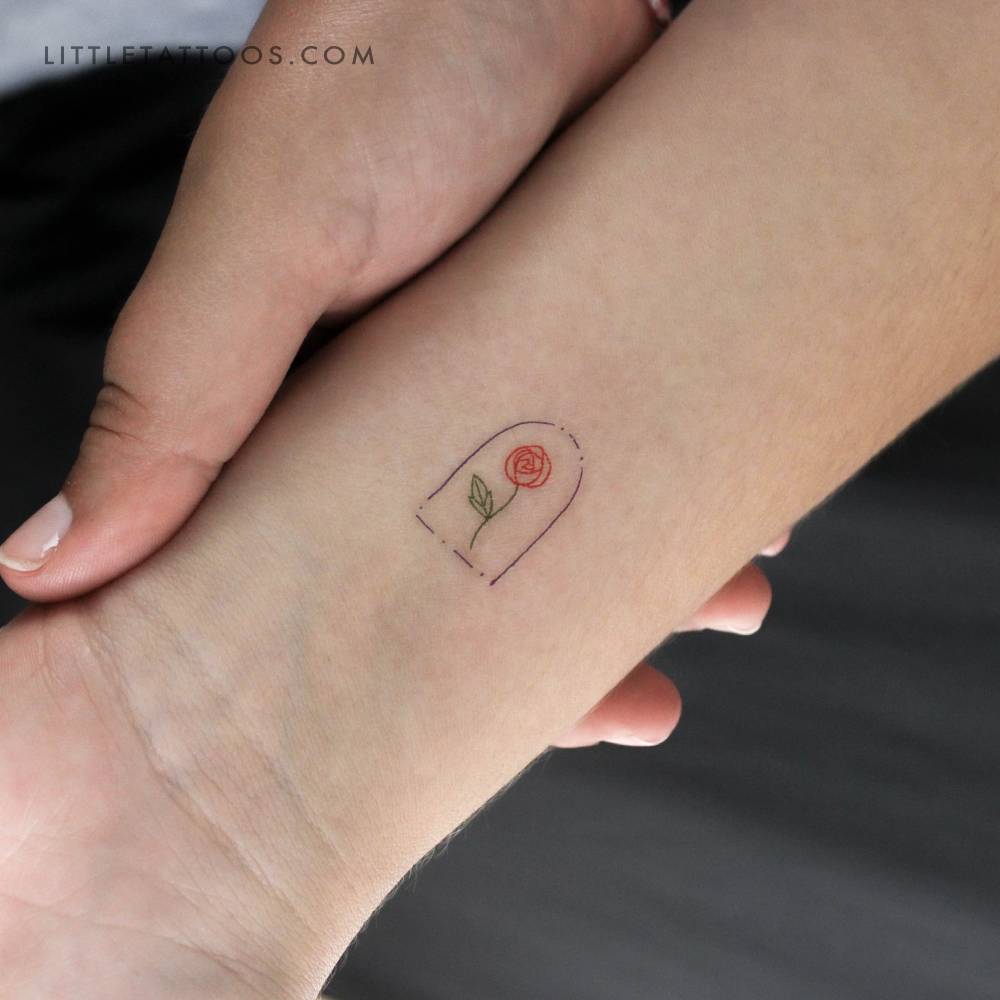 Minimalist rose in a glass dome temporary tattoo located on the wrist.