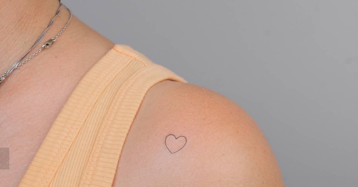 Minimalistic style heart tattoo located on the