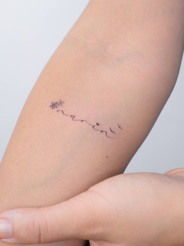 Name "Narin" tattooed on the inner forearm.