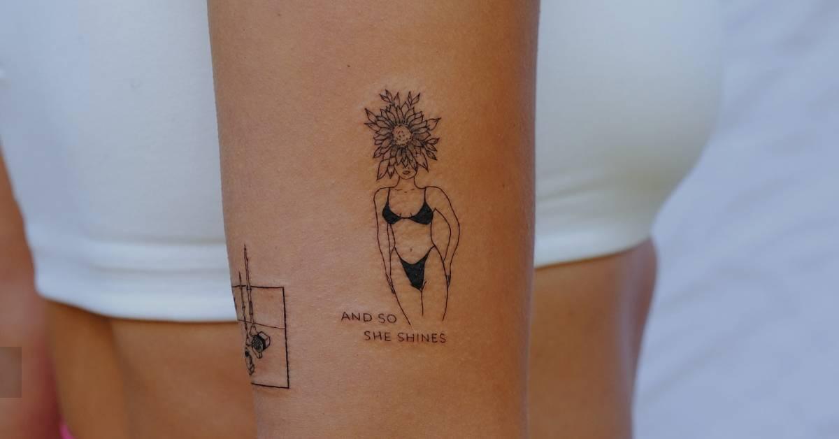 Flower head woman tattoo located on the upper arm,