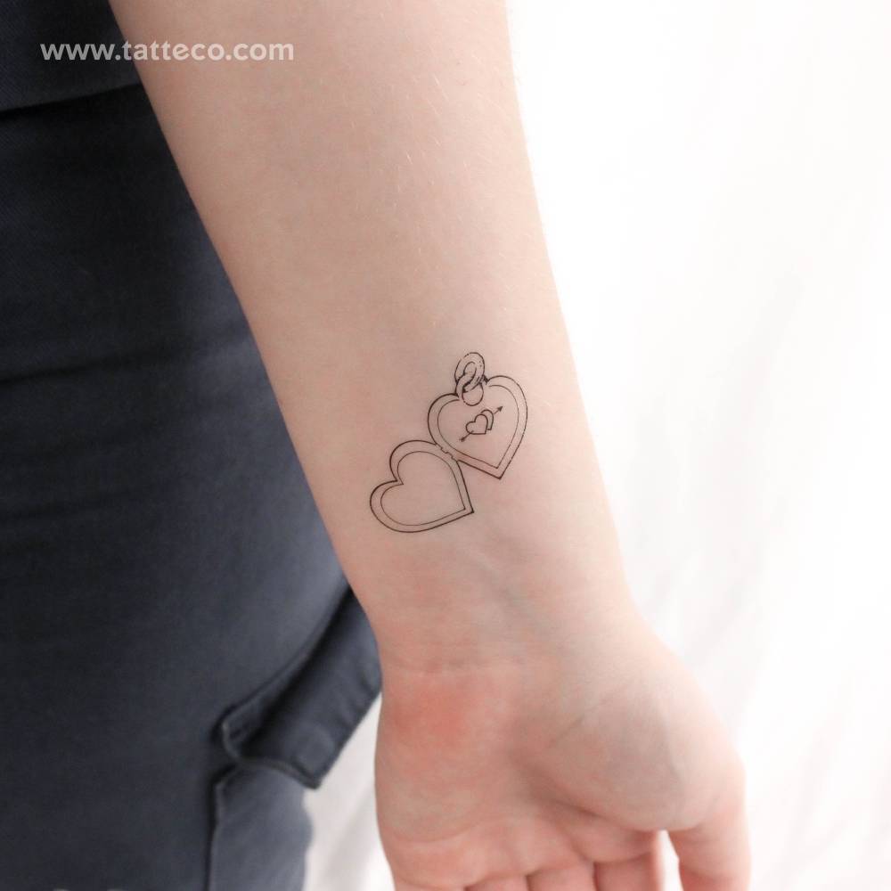 Fine line style heart pendant temporary tattoo located on the wrist.