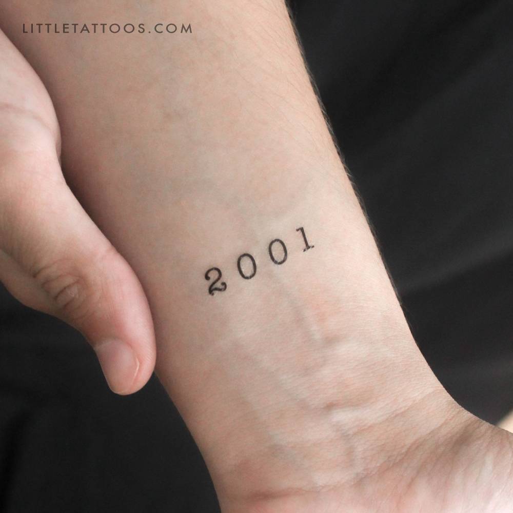 "2001" birth year temporary tattoo located on the wrist.