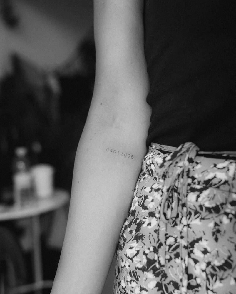 Date tattoo located on the inner forearm.