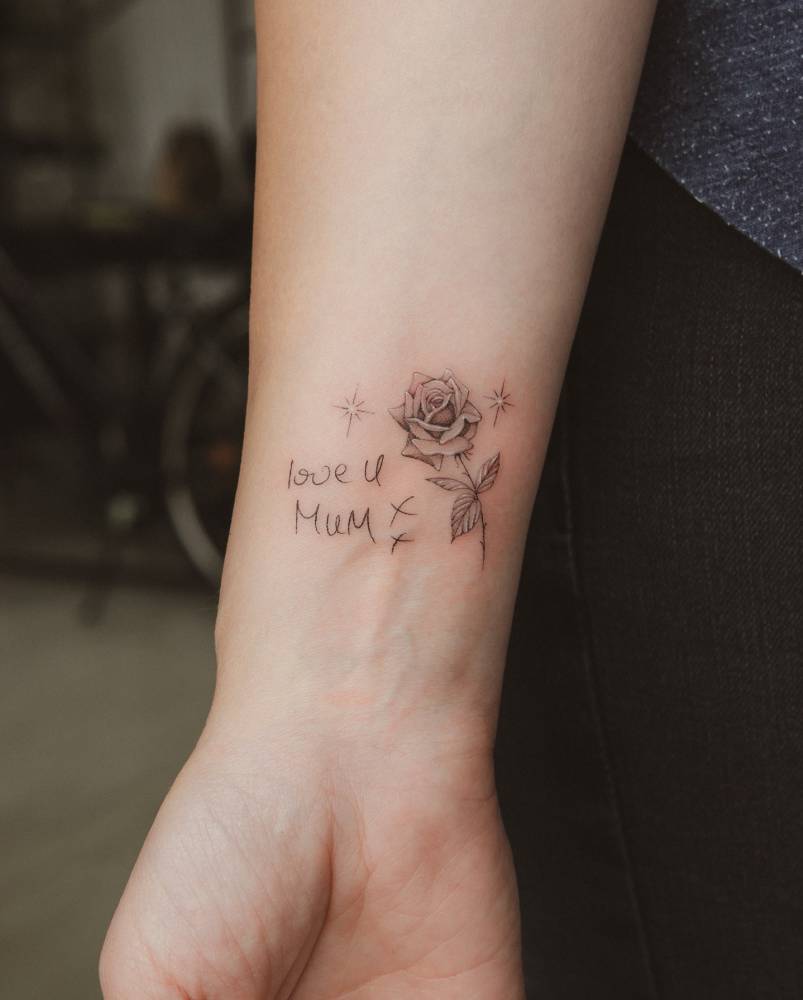 Rose and mum's handwriting tattooed on the wrist.