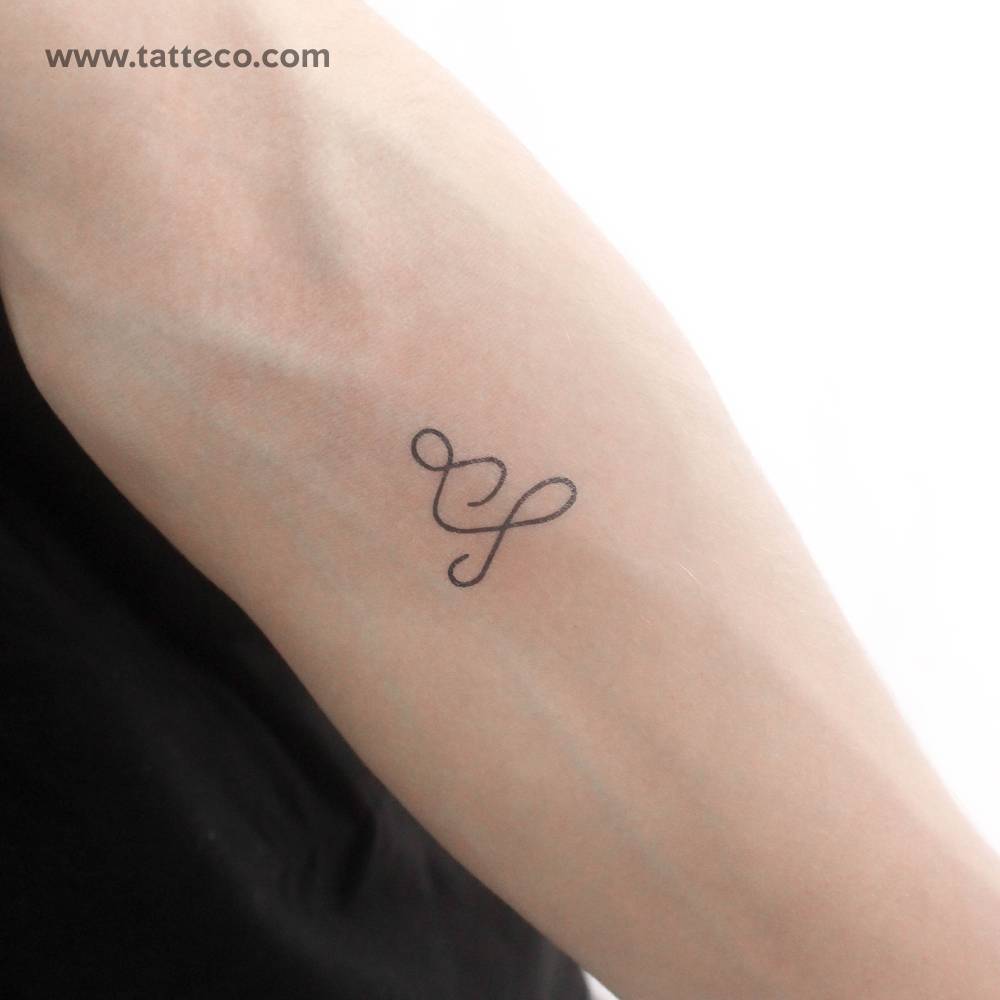 Minimalist one line meditator temporary tattoo located on the inner forearm.