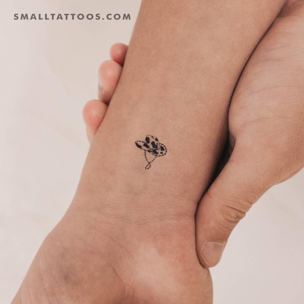 Cow skin hat temporary tattoo located on the wrist.