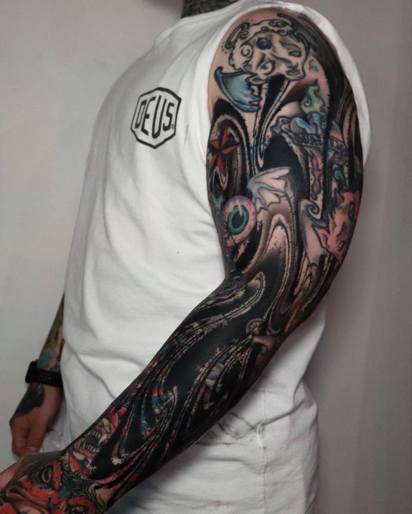 Blackwork style abstract sleeve cover-up tattoo.