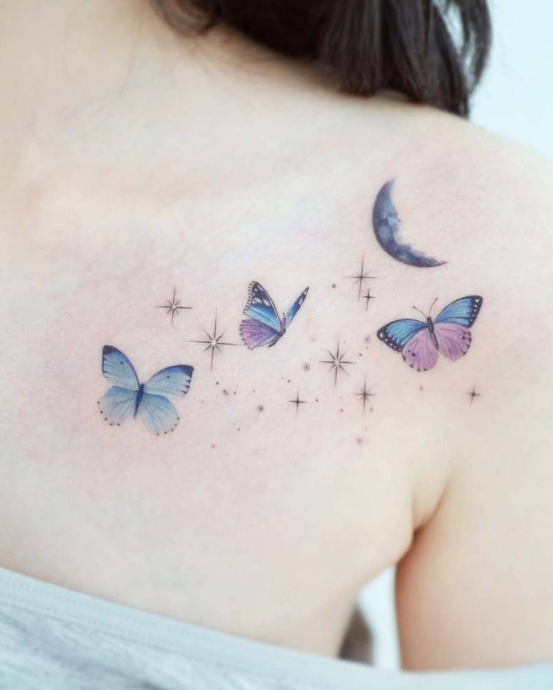 Blue butterflies tattoo in watercolor style located on the shoulder blade.
