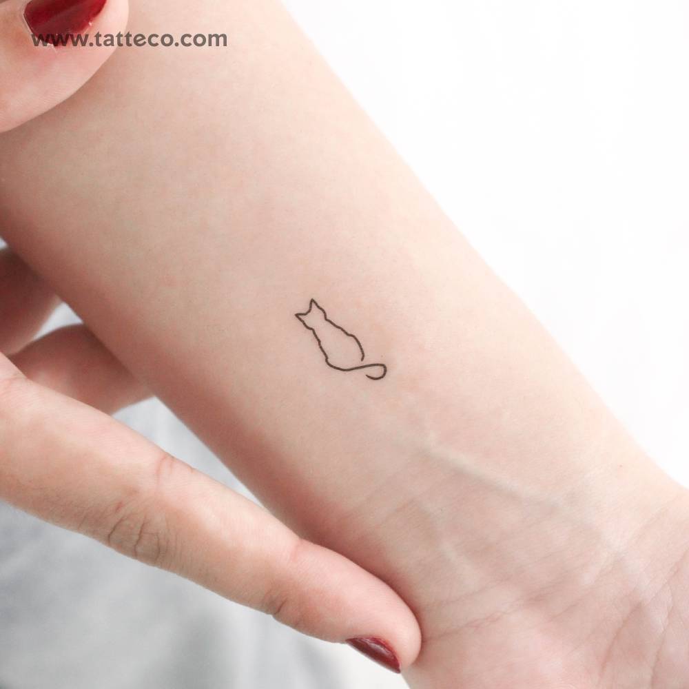 Line art cat temporary tattoo located on the wrist.