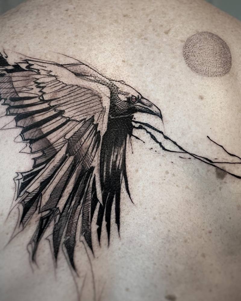 Sketch work style raven tattoo located on the upper back.