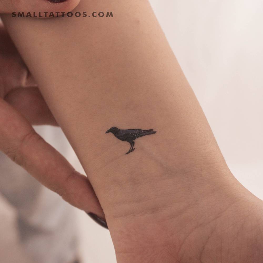 Small raven temporary tattoo located on the wrist.