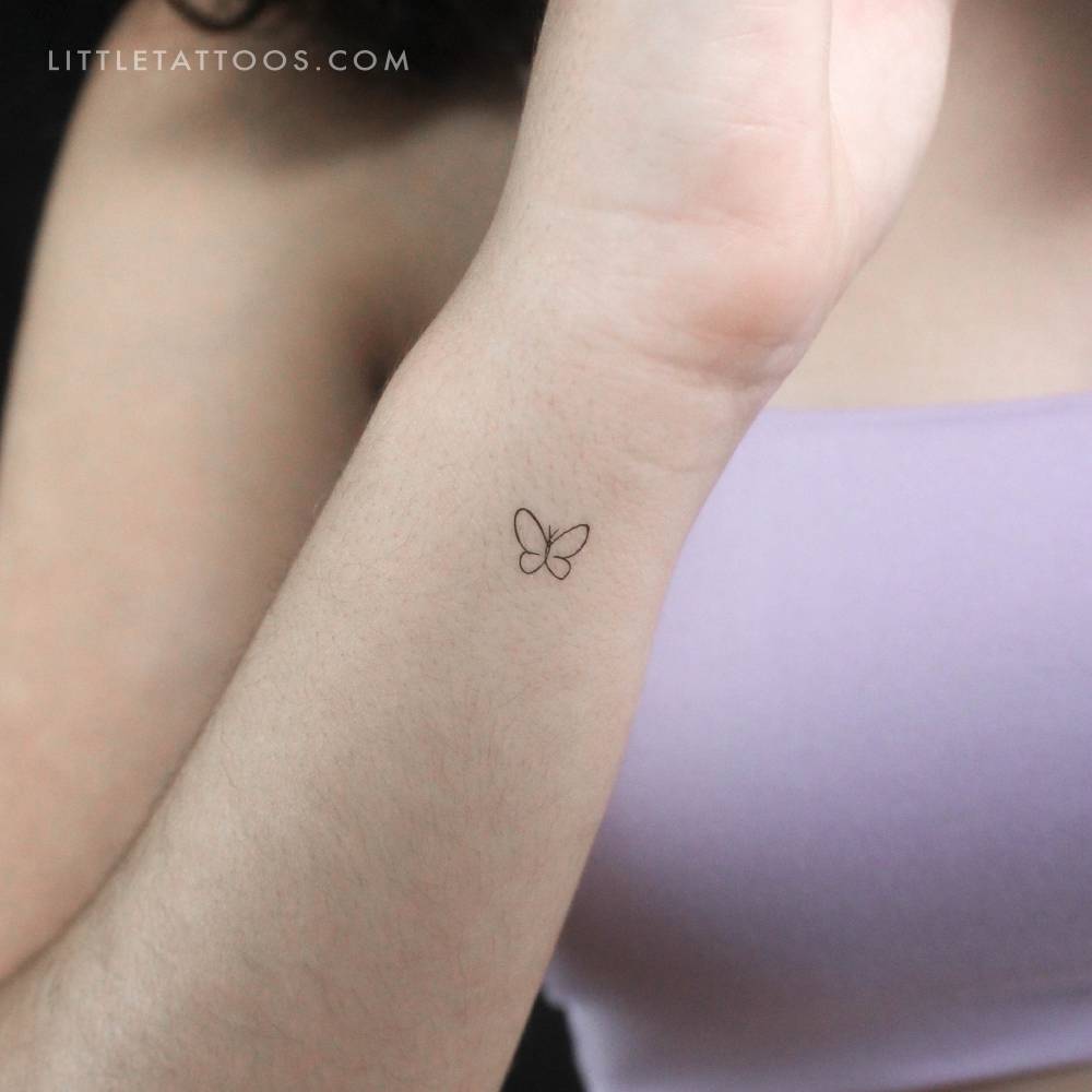 Tiny single line butterfly temporary tattoo located on the wrist.