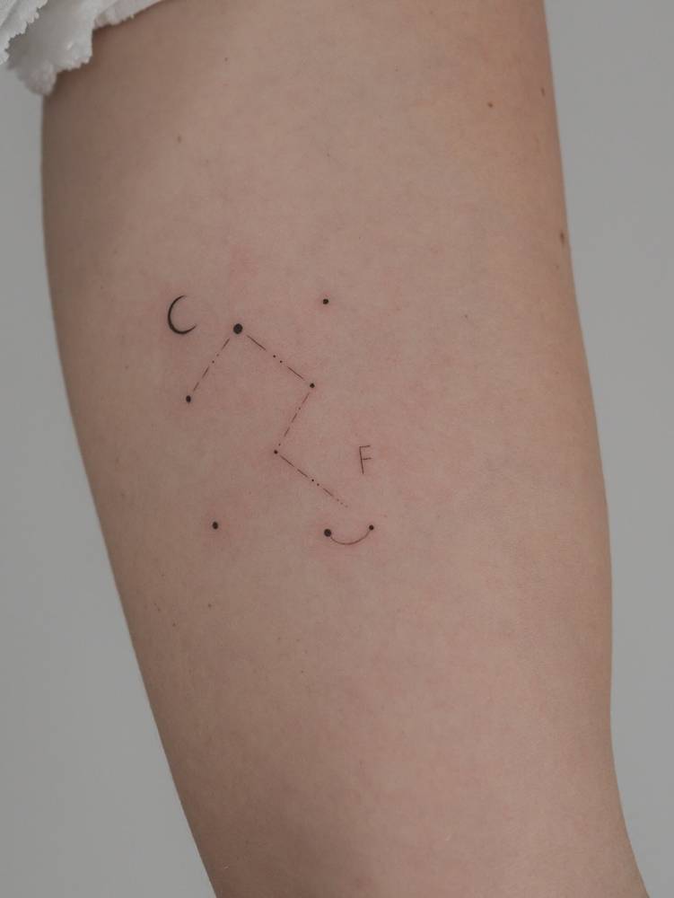 Single needle Aquarius constellation tattoo located on the inner arm.