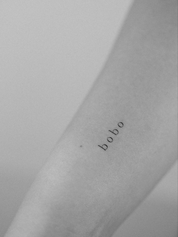 "Bobo" lettering tattoo located on the wrist.