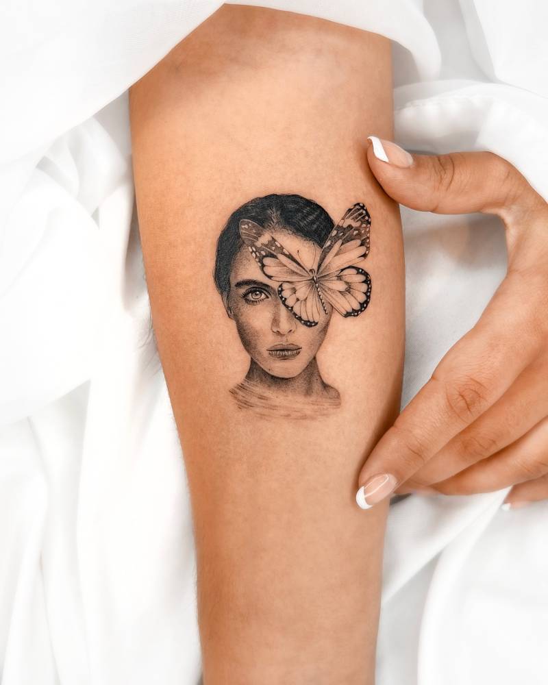 Micro-realistic style butterfly woman tattoo placed on the inner forearm.